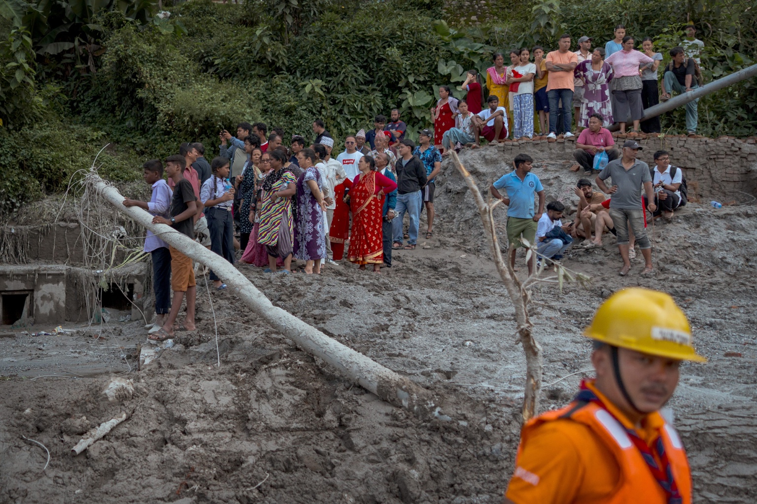 Residents and responders gather in a flood-affected area of Nepal.